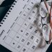 brown framed eyeglasses on a calendar